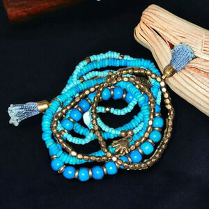 6 Blue Beaded Stackable Stretch Bracelets with Tassels and Gold Tone Hand Charms